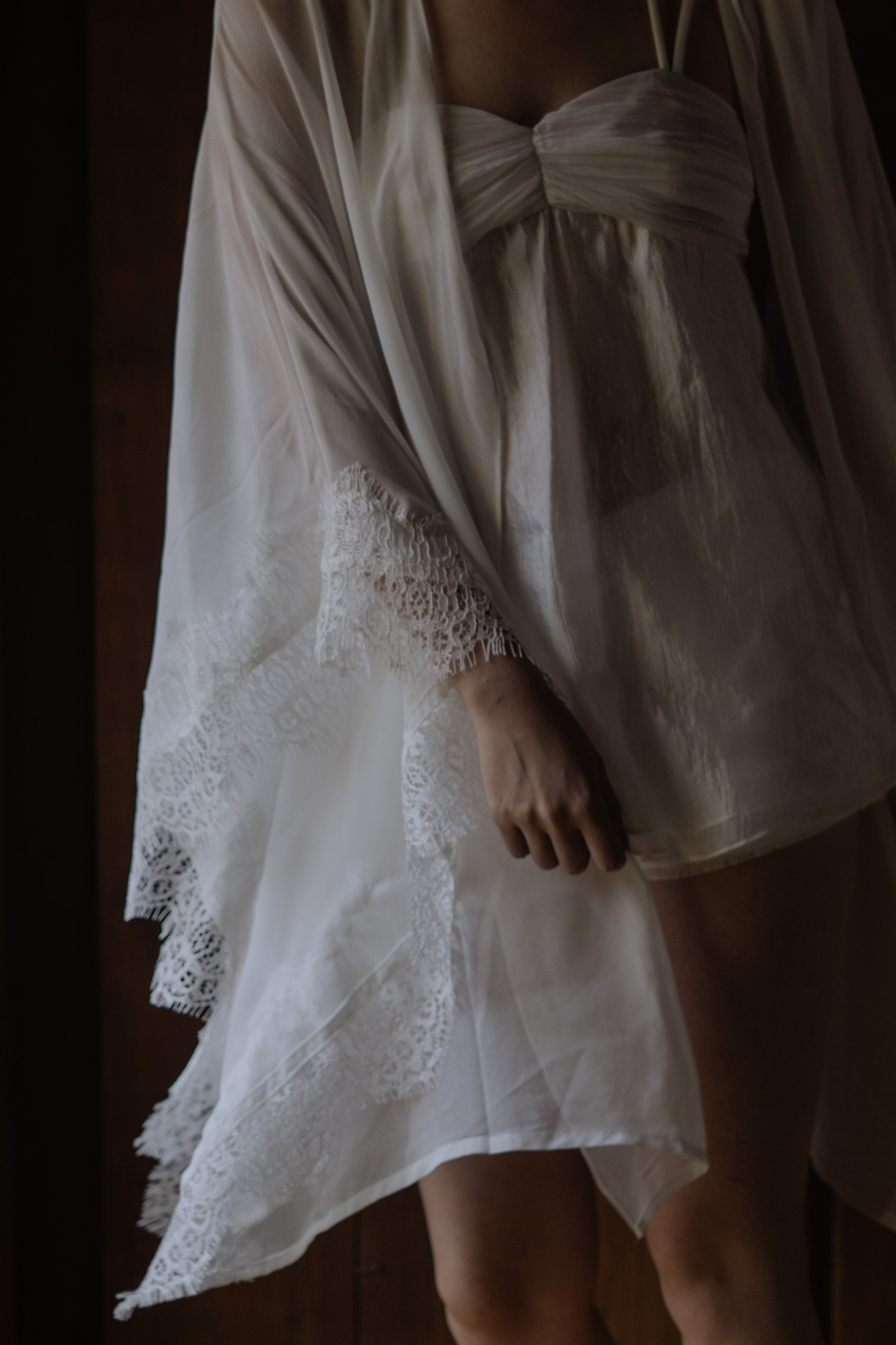 A bride in an off-shoulder beaded bodice and soft tulle skirt.