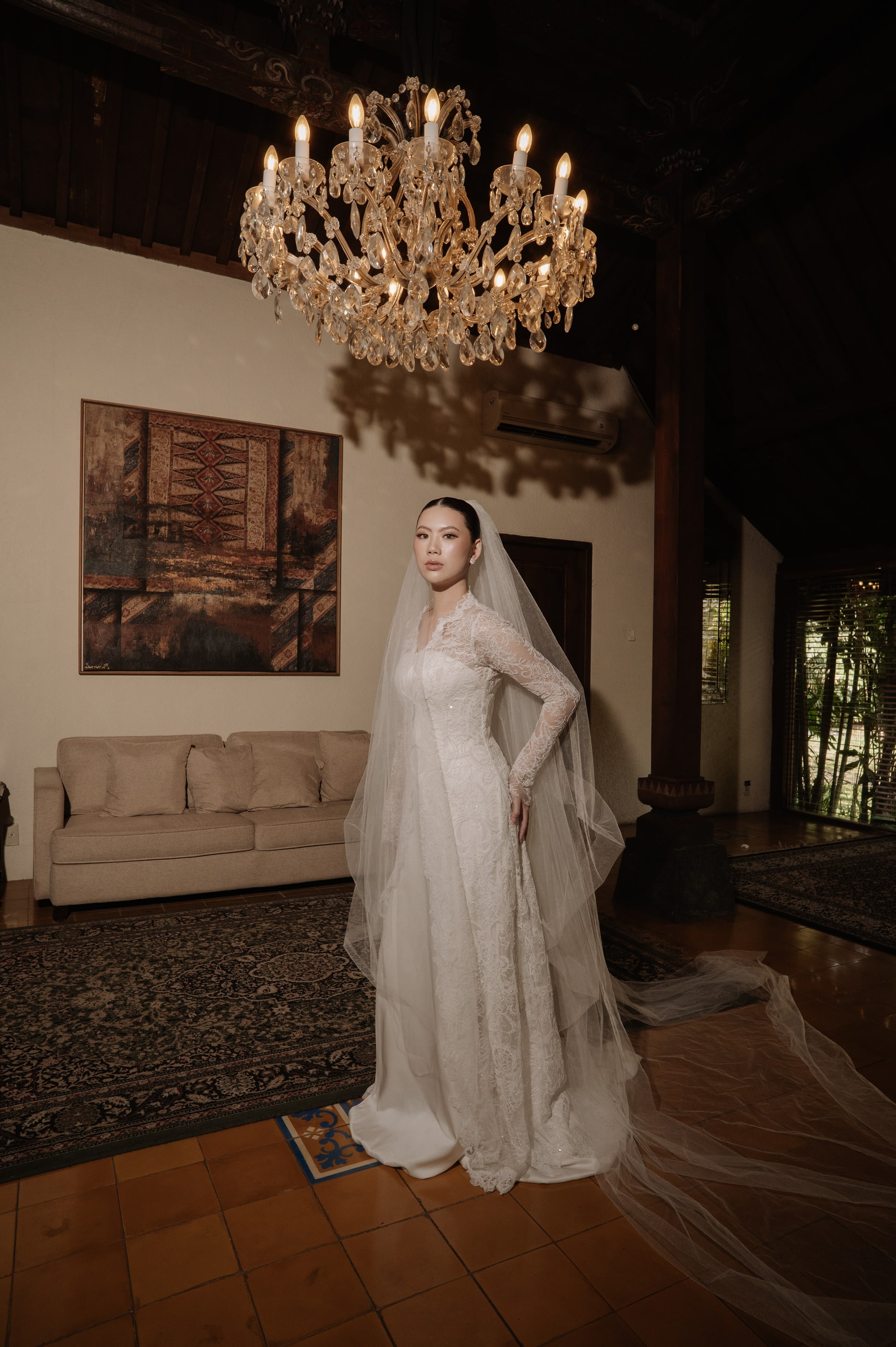 A bride photographed full length in soft daylight.